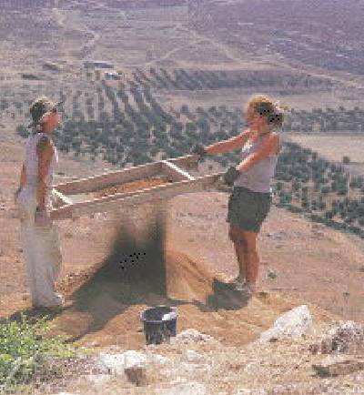Sifting sand for the finds.