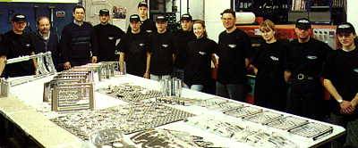 The De Pretto Moto team The De Pretto Moto team in the factory with a range of components on display.
