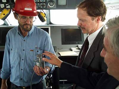 Mark Dewey, Incat shipyard liaison manager shows John Ryan, VP Sales CADKEY, and Barry Dyson Australian CADKEY distributor the helm in a Revolution 120 wheelhouse during fit out.